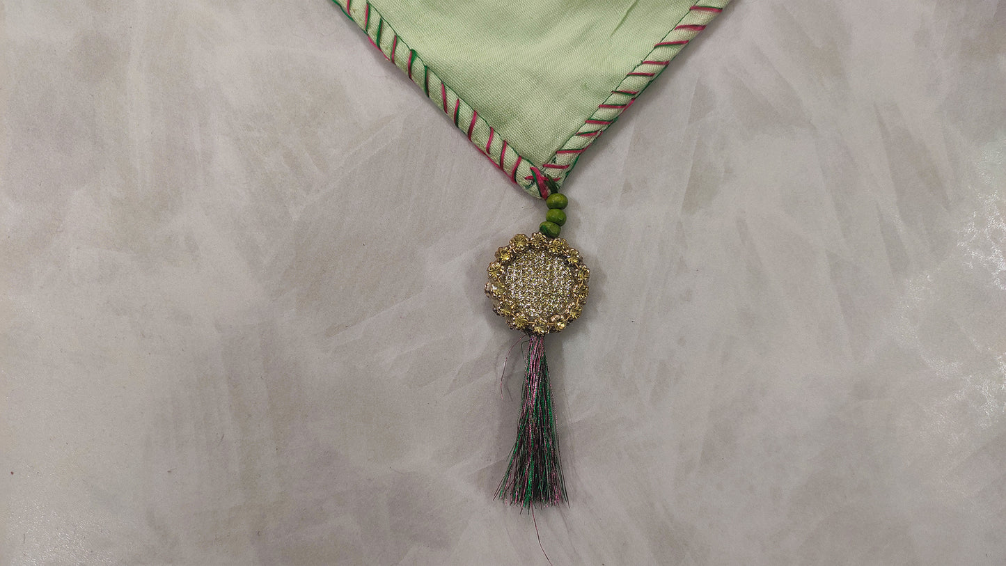 Hand embroidered with pink and green cotton thread with golden zari, this handcrafted table runner is paired with set of 6 lap napkins. Designed to be double sided