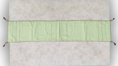 Hand embroidered with pink and green cotton thread with golden zari, this handcrafted table runner is paired with set of 6 lap napkins. Designed to be double sided.