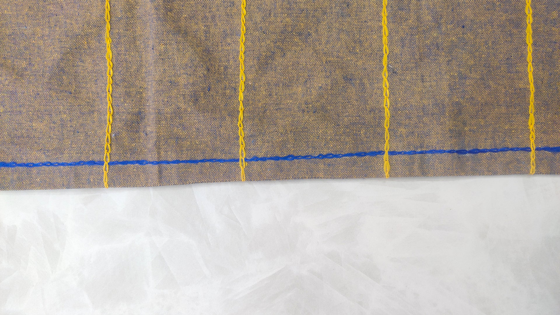 Hand embroidered with purple and yellow golden cotton thread, this handcrafted table runner is paired with set of 6 lap napkins. Designed to be double sided.