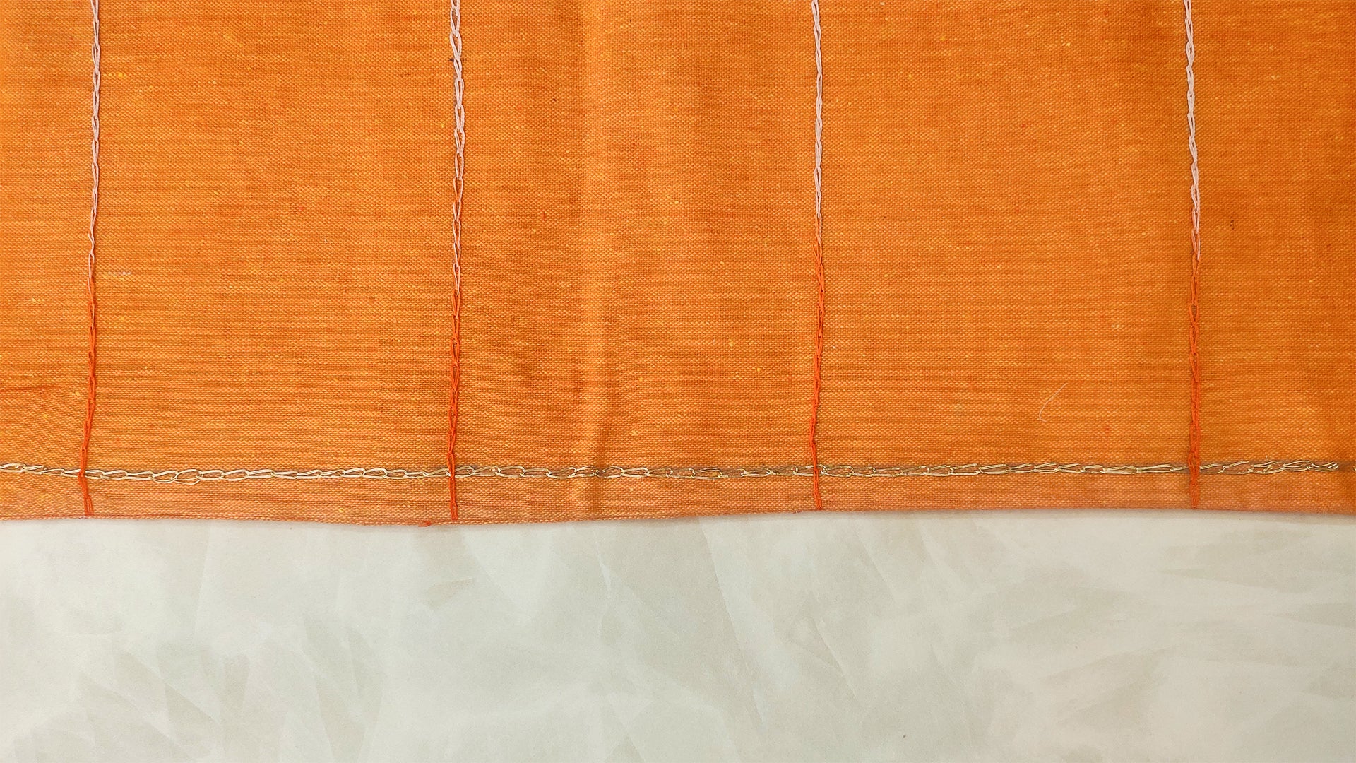 Hand embroidered with off white cotton thread with golden zari, this handcrafted table runner is designed to be double sided.