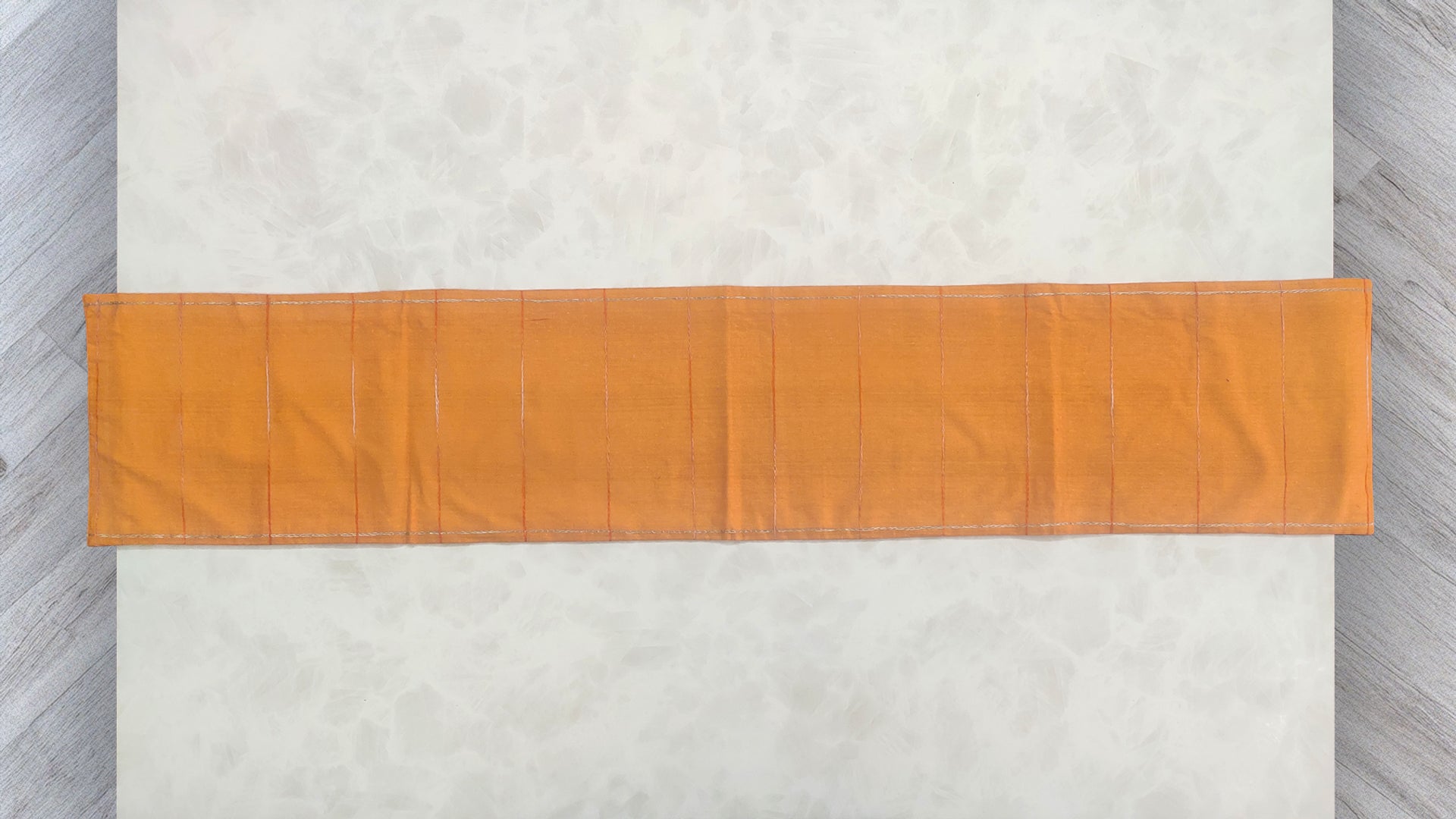 Hand embroidered with off white cotton thread with golden zari, this handcrafted table runner is designed to be double sided.