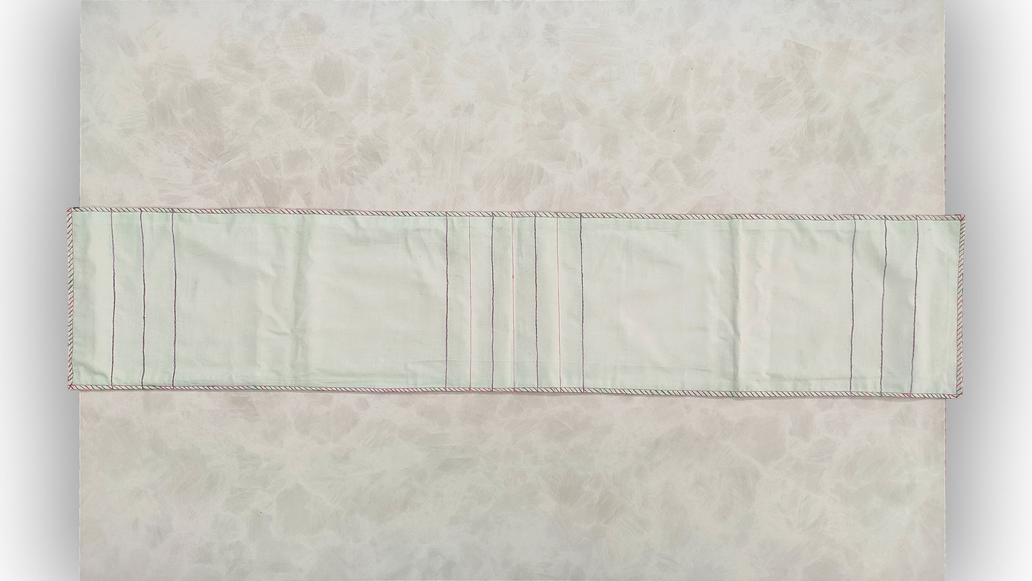 Hand embroidered with pink and purple cotton thread with golden zari, this handcrafted table runner is paired with set of 6 lap napkins. Designed to be double sided.