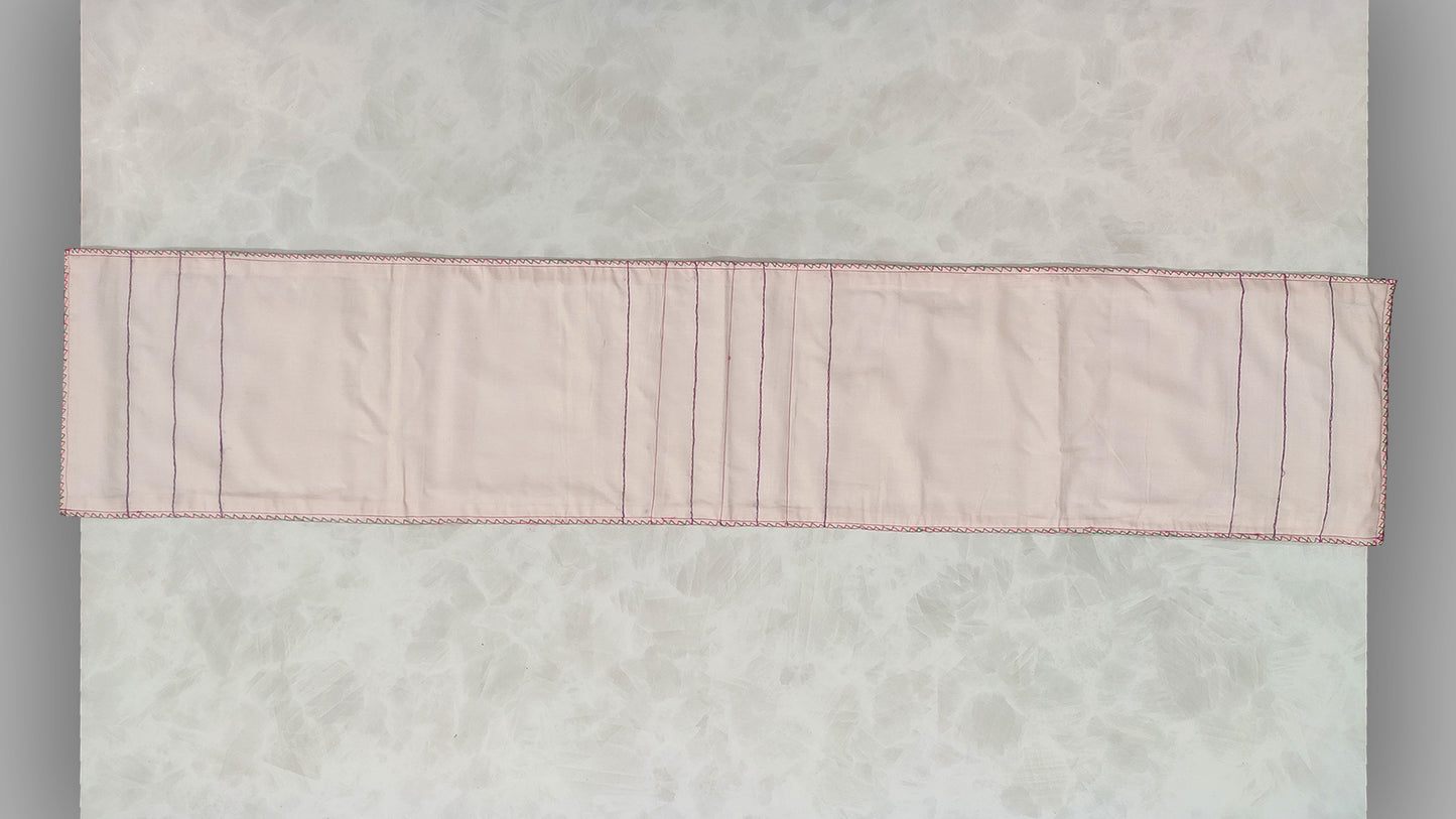 Hand embroidered with pink and purple cotton thread with golden zari, this handcrafted table runner is paired with set of 6 lap napkins. Designed to be double sided.